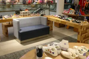 A living room filled with lots of shoes on the floor.