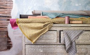 Fabric swatches on ornate chest of drawers